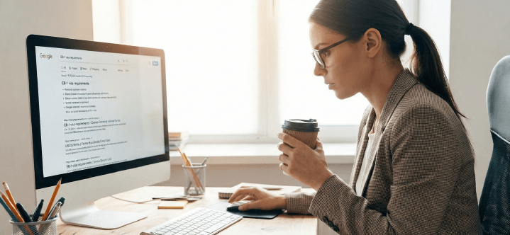 Professional researching EB-1 extraordinary ability visa requirements on a computer