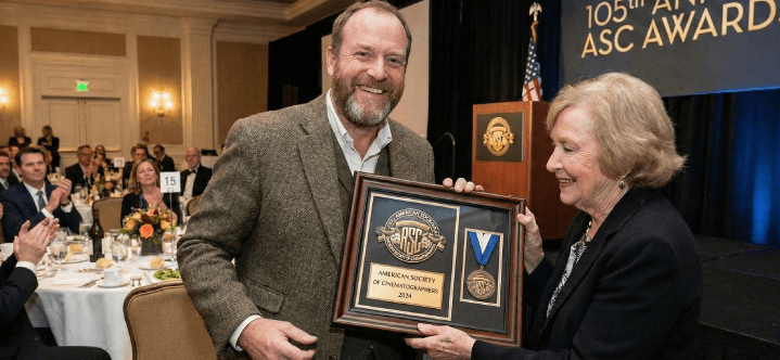 Professional receiving a prestigious industry award during a formal recognition ceremony